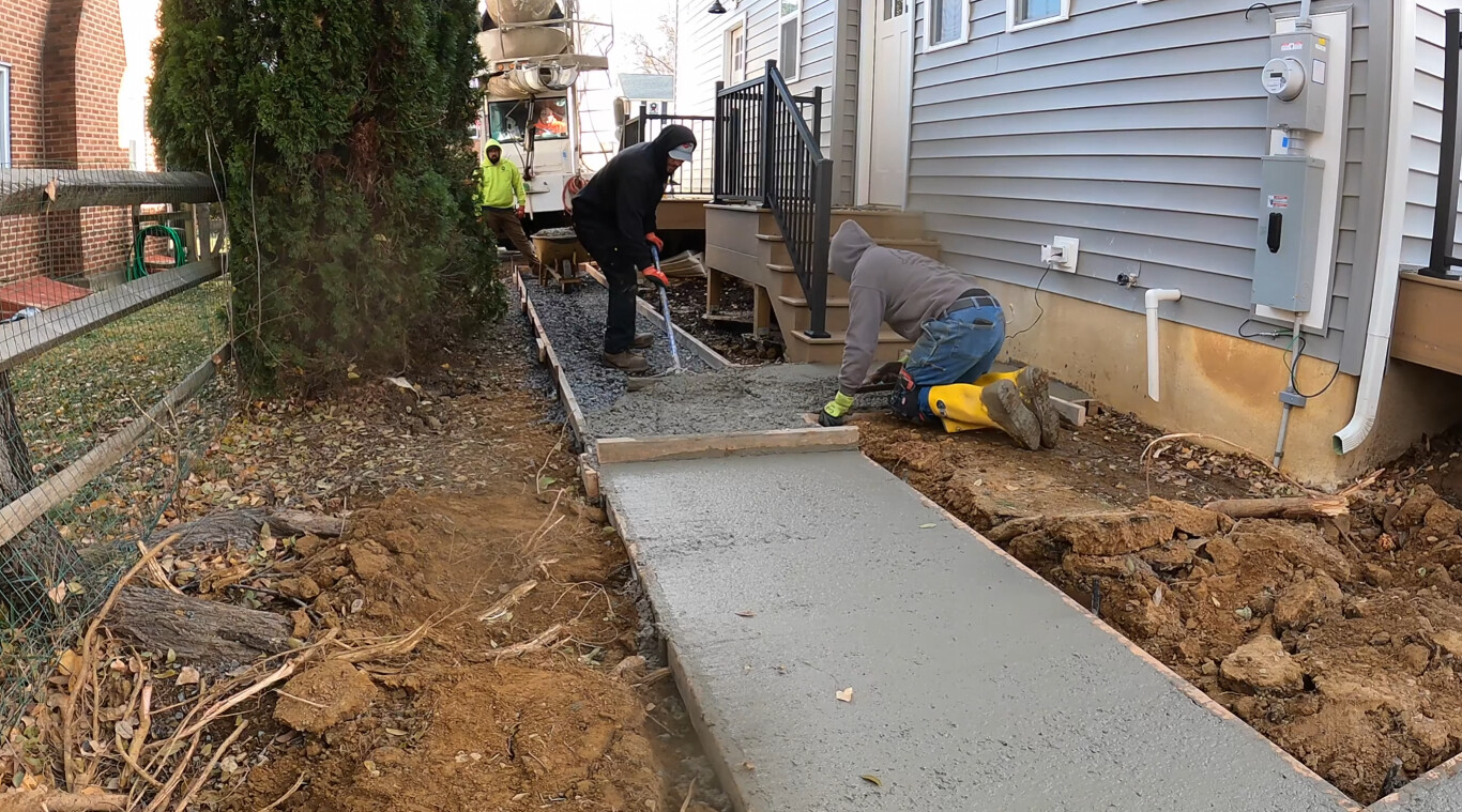 Professional concrete sidewalk installation in progress in Portland, ME